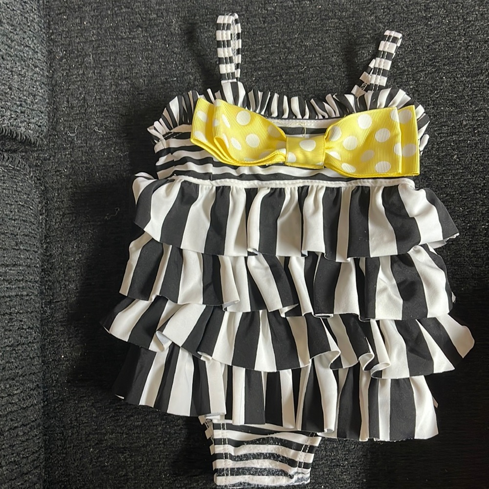 Mud Pie baby girl swimsuit. Size 0 - 6 months. Some snags on the bottom.